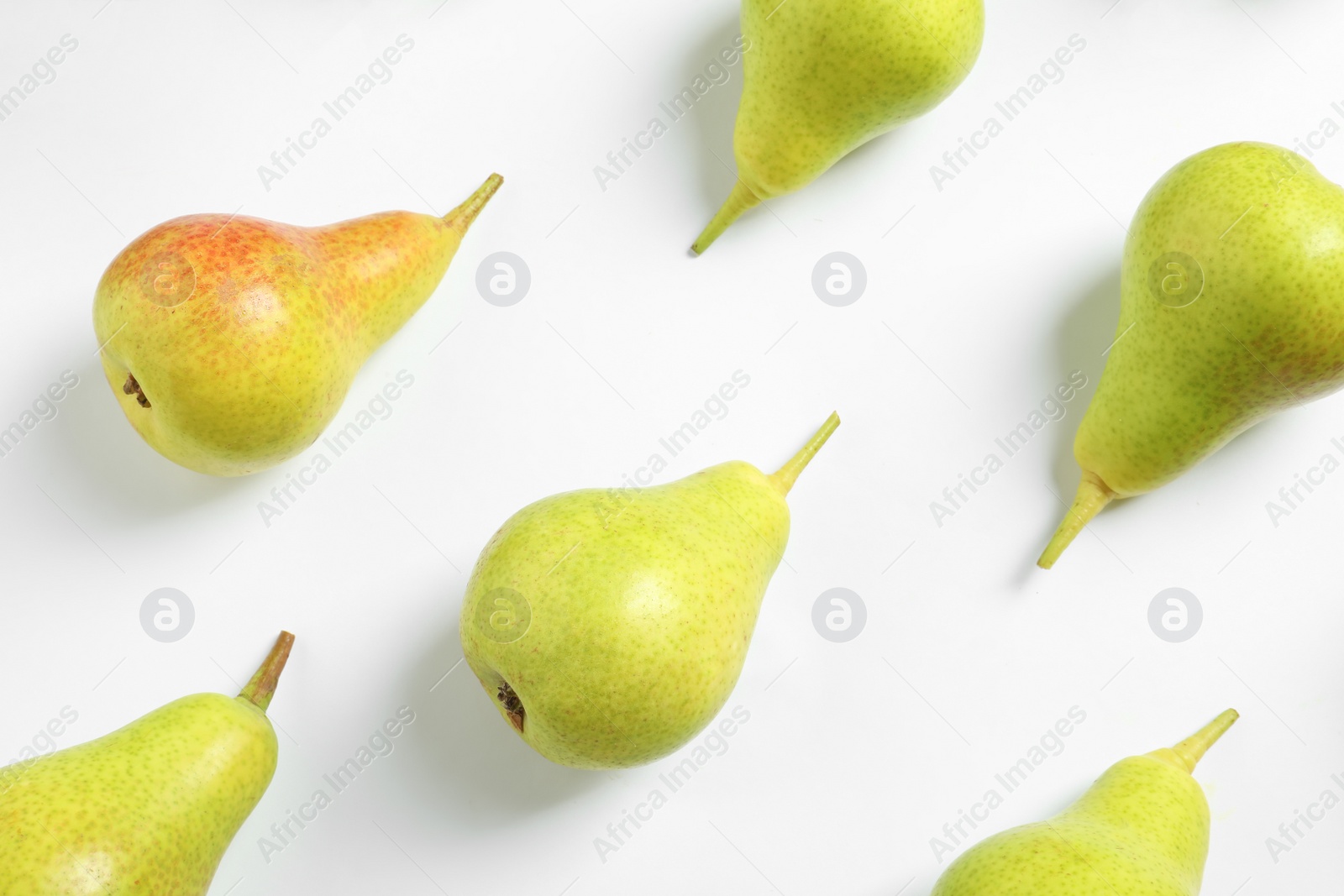 Photo of Ripe juicy pears on white background, top view