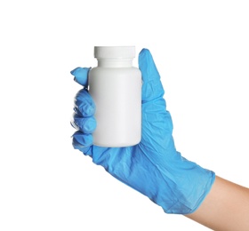 Doctor in medical glove holding bottle with pills on white background