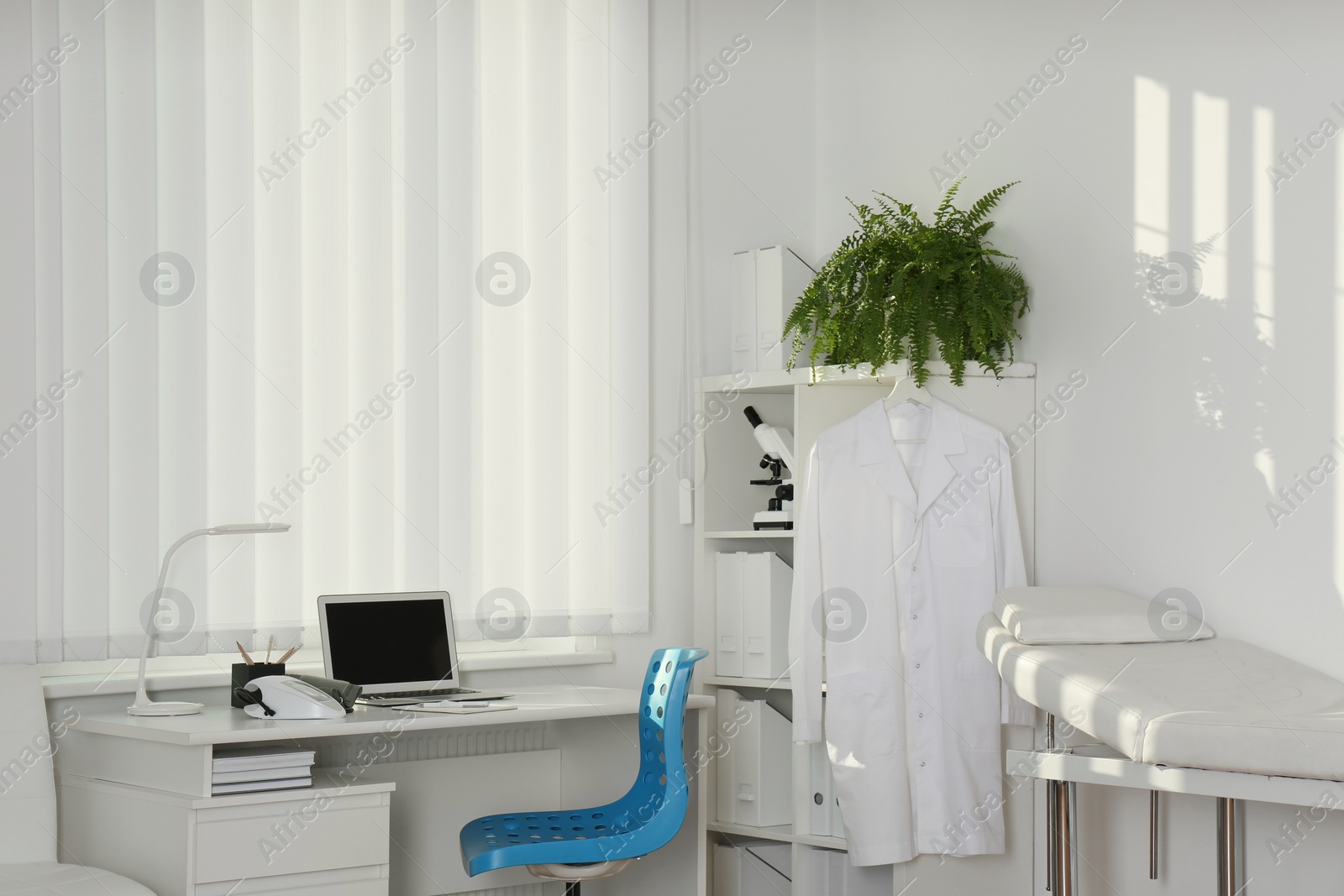 Photo of Interior of modern medical office with doctor's workplace