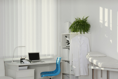 Interior of modern medical office with doctor's workplace