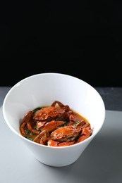 Photo of Delicious boiled crabs with sauce on table, space for text