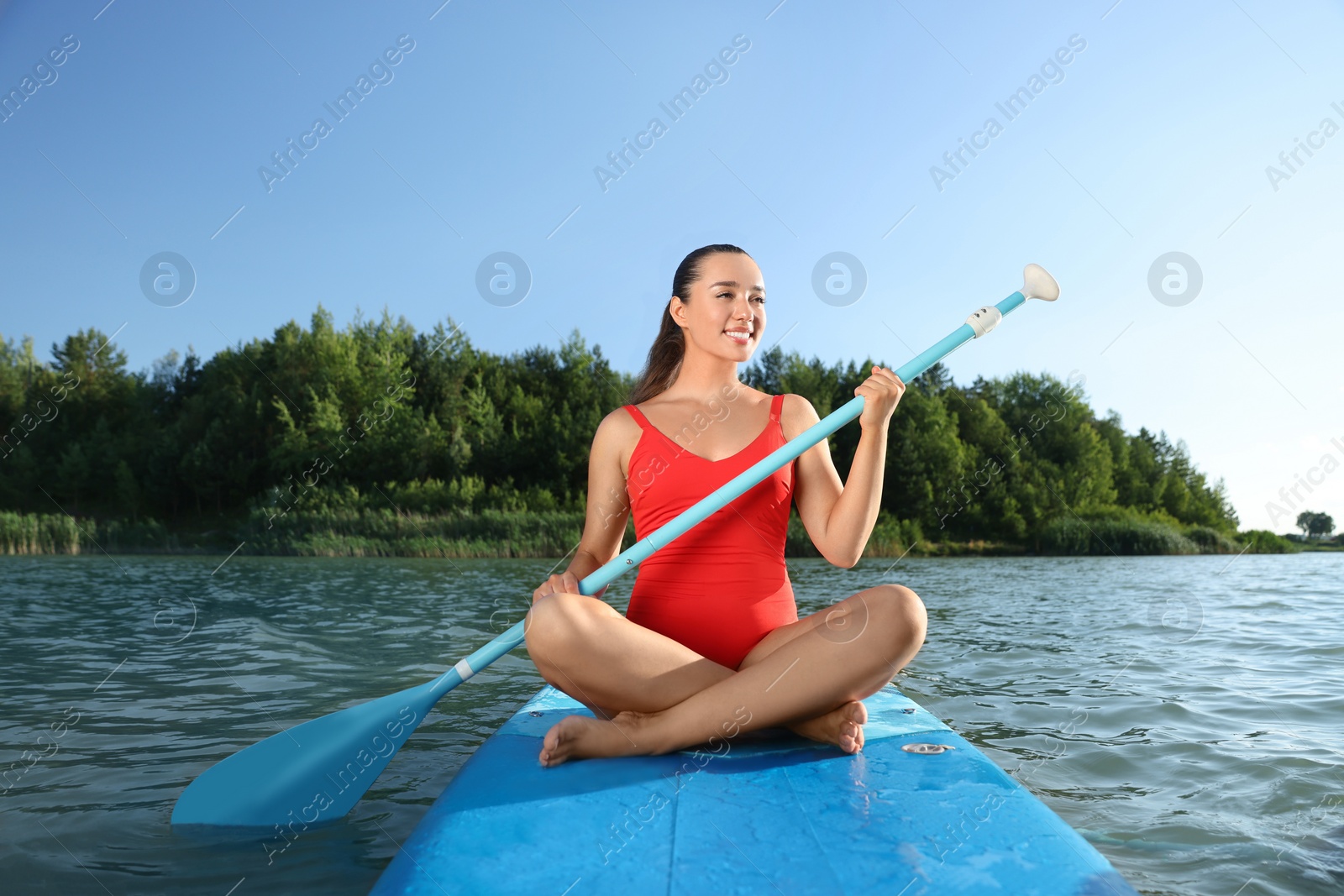 Photo of Woman paddle boarding on SUP board in river