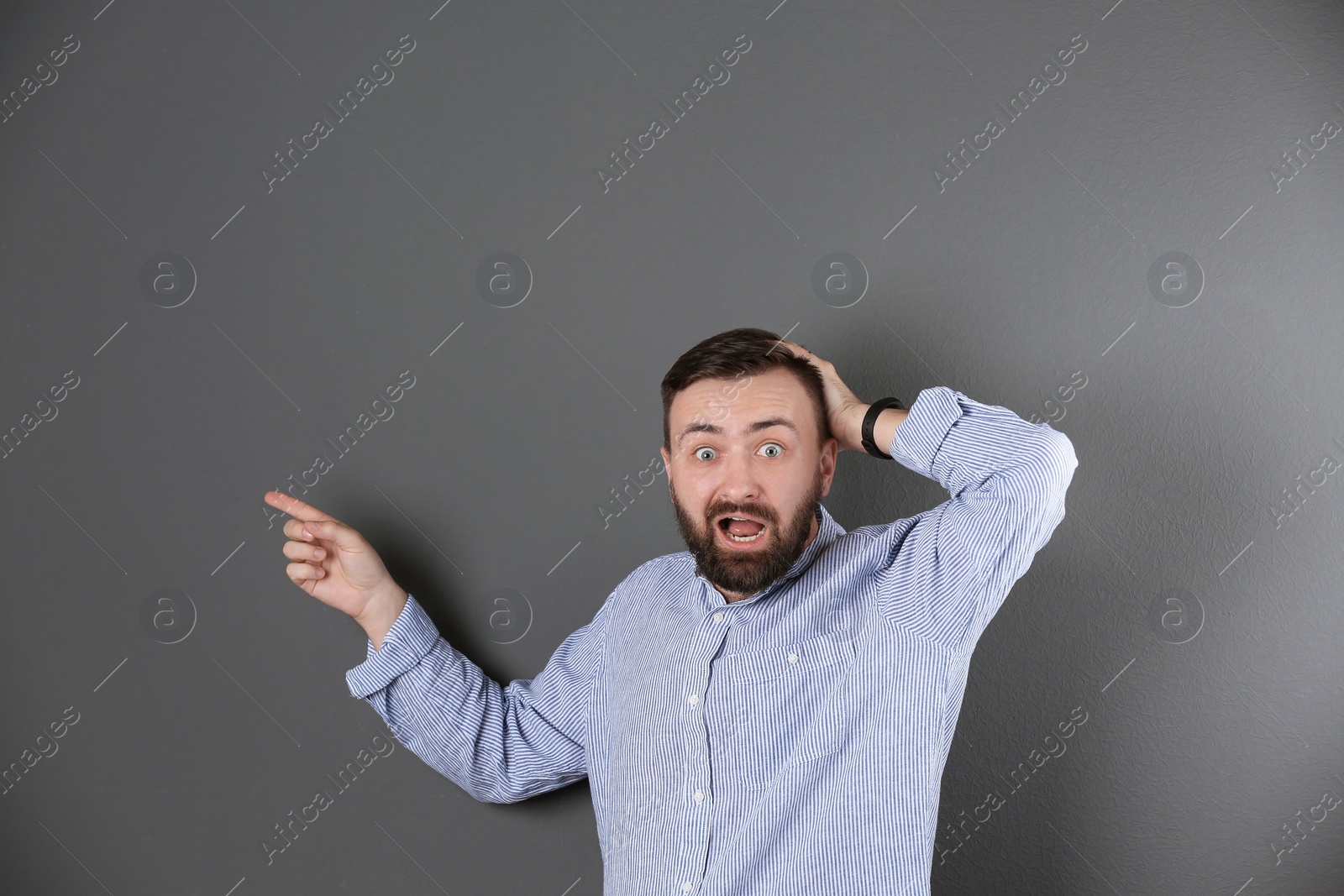 Photo of Portrait of handsome bearded man on color background