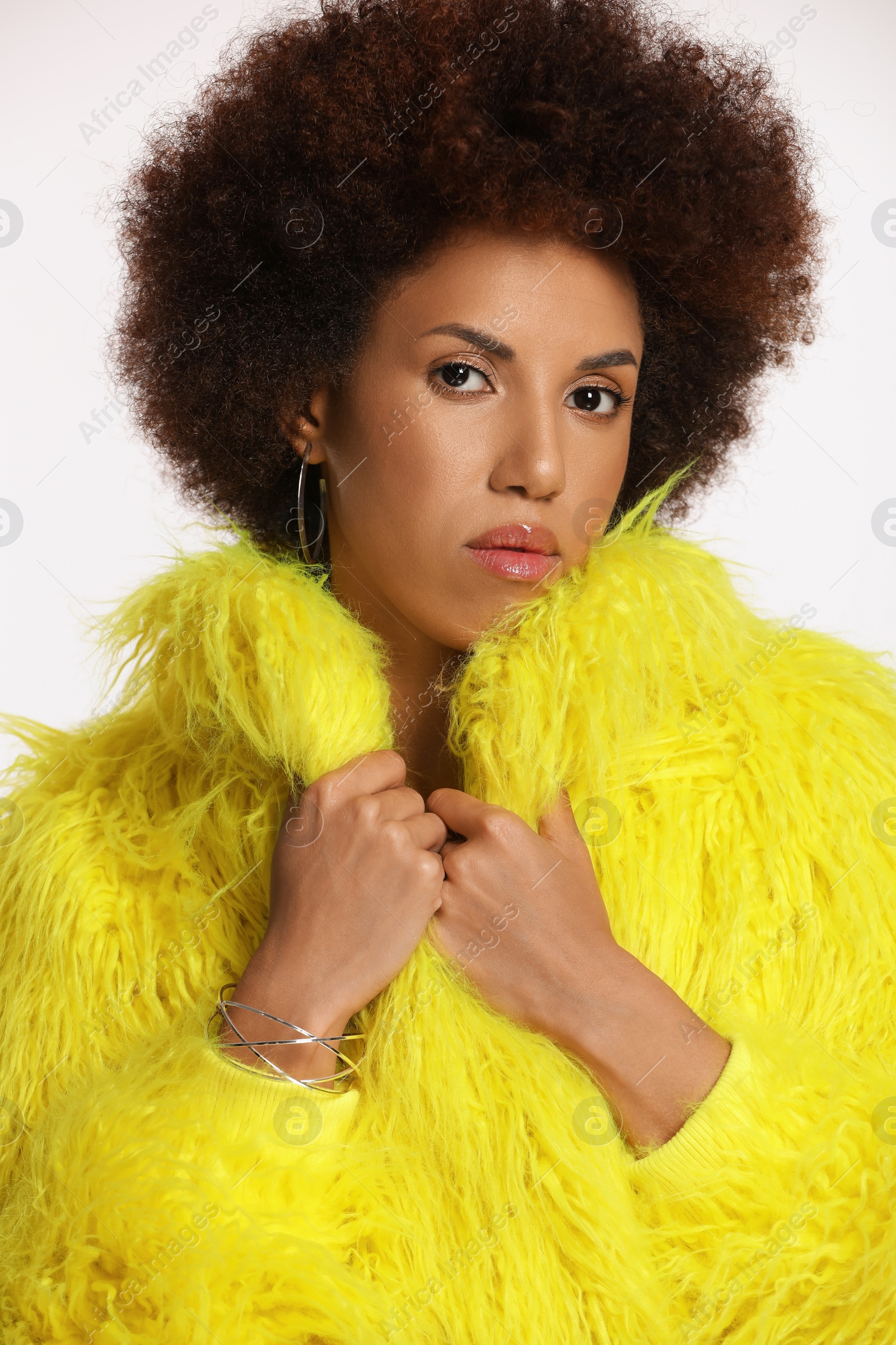 Photo of Portraitbeautiful young woman in stylish yellow fur coat on white background