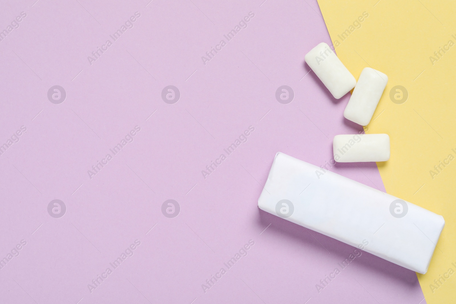 Photo of Pack with tasty chewing gums on color background, flat lay. Space for text