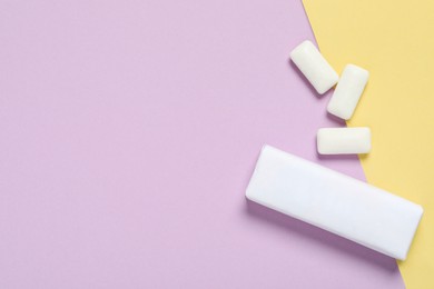 Photo of Pack with tasty chewing gums on color background, flat lay. Space for text