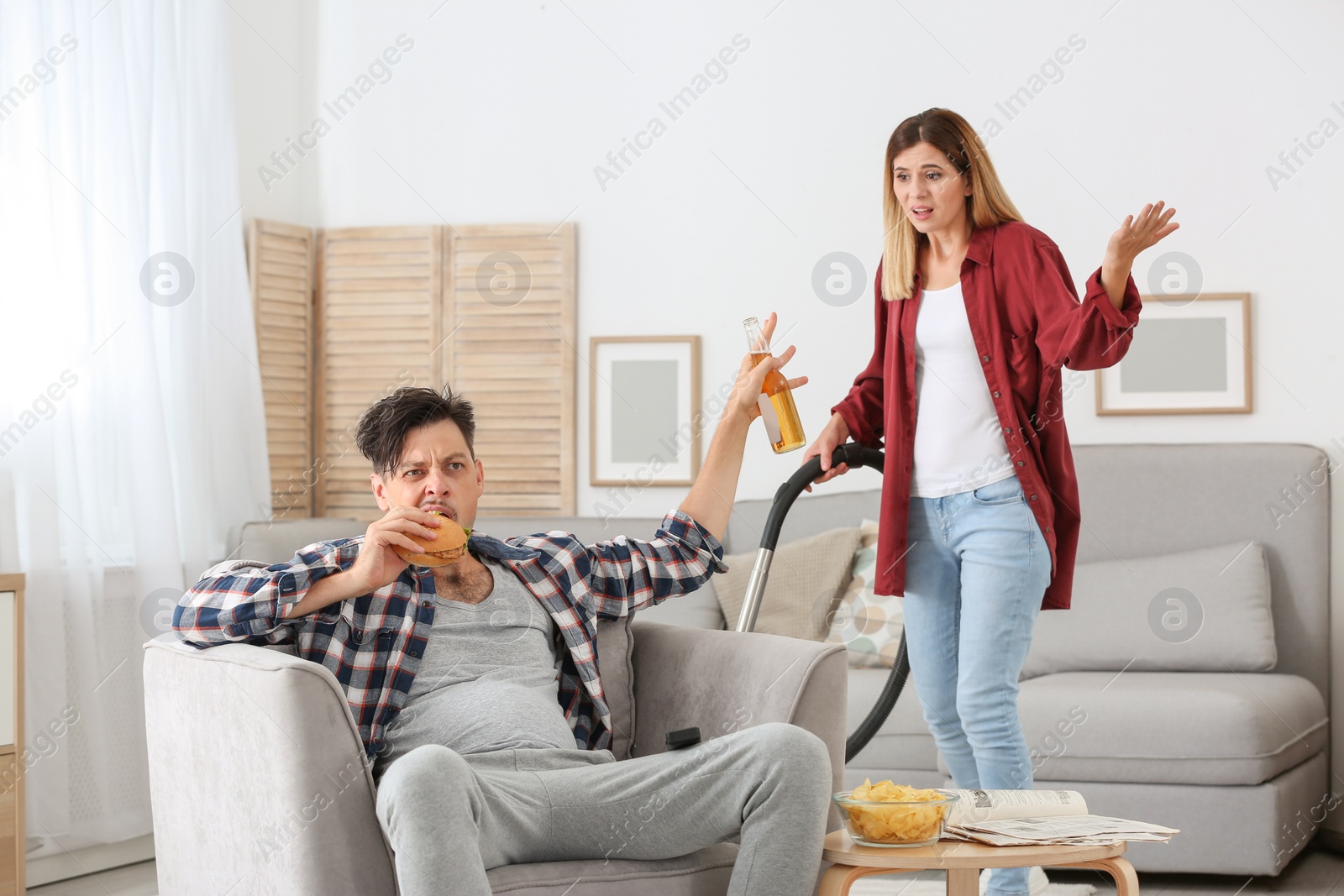 Photo of Lazy husband quarrelling with hardworking wife at home