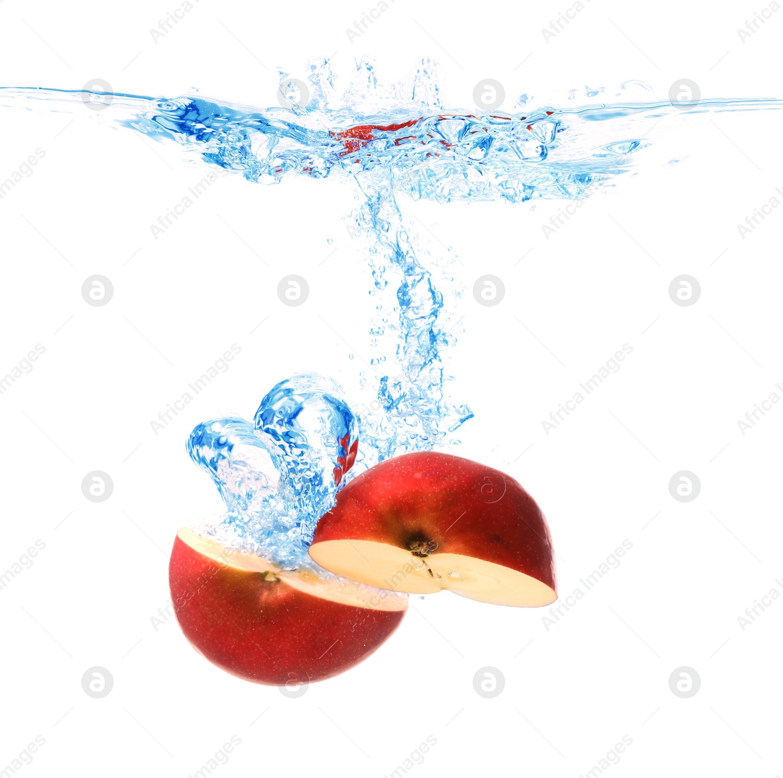 Photo of Cut apple falling down into clear water against white background