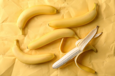 Fresh yummy bananas on color paper background