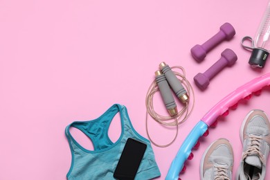 Photo of Flat lay composition with sports equipment on pink background, space for text