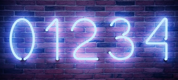 Image of Glowing neon number (0, 1, 2, 3, 4) signs on brick wall