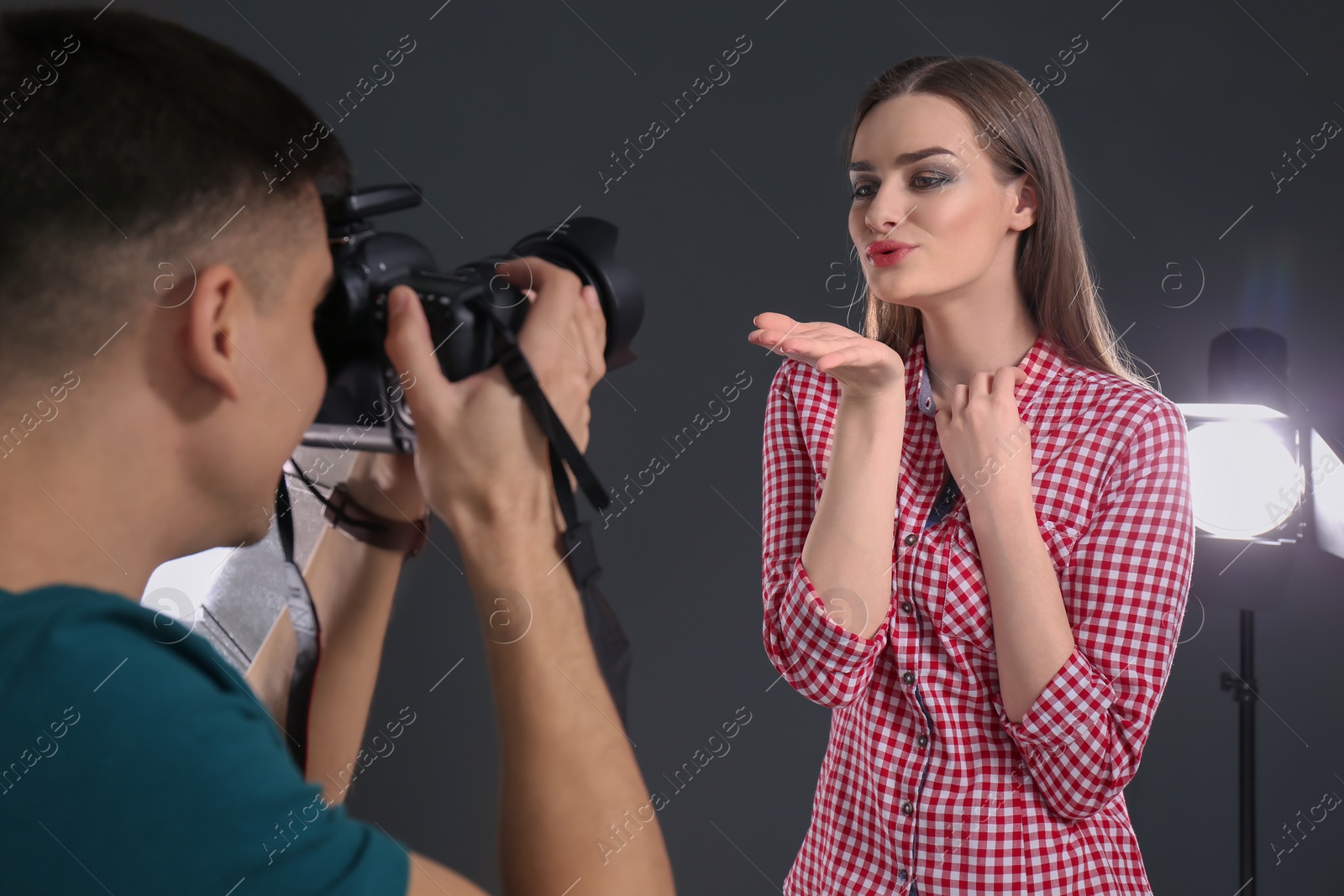 Photo of Beautiful young model posing for professional photographer in studio