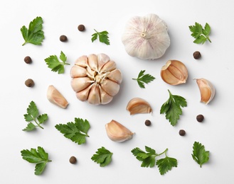 Flat lay composition with green parsley, pepper and garlic on white background