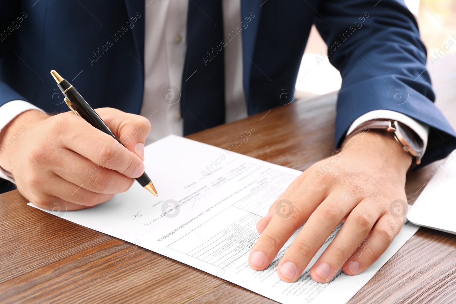 Photo of Lawyer working with documents at table, focus on hands