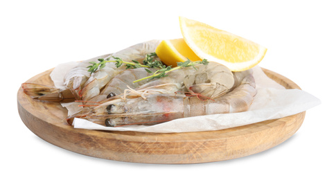 Wooden plate with raw shrimps, lemon slices and thyme isolated on white