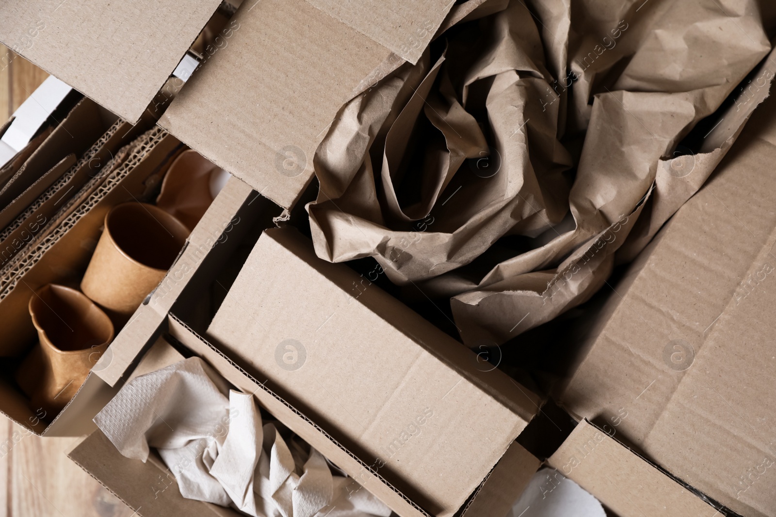 Photo of Different waste paper on wooden table, flat lay