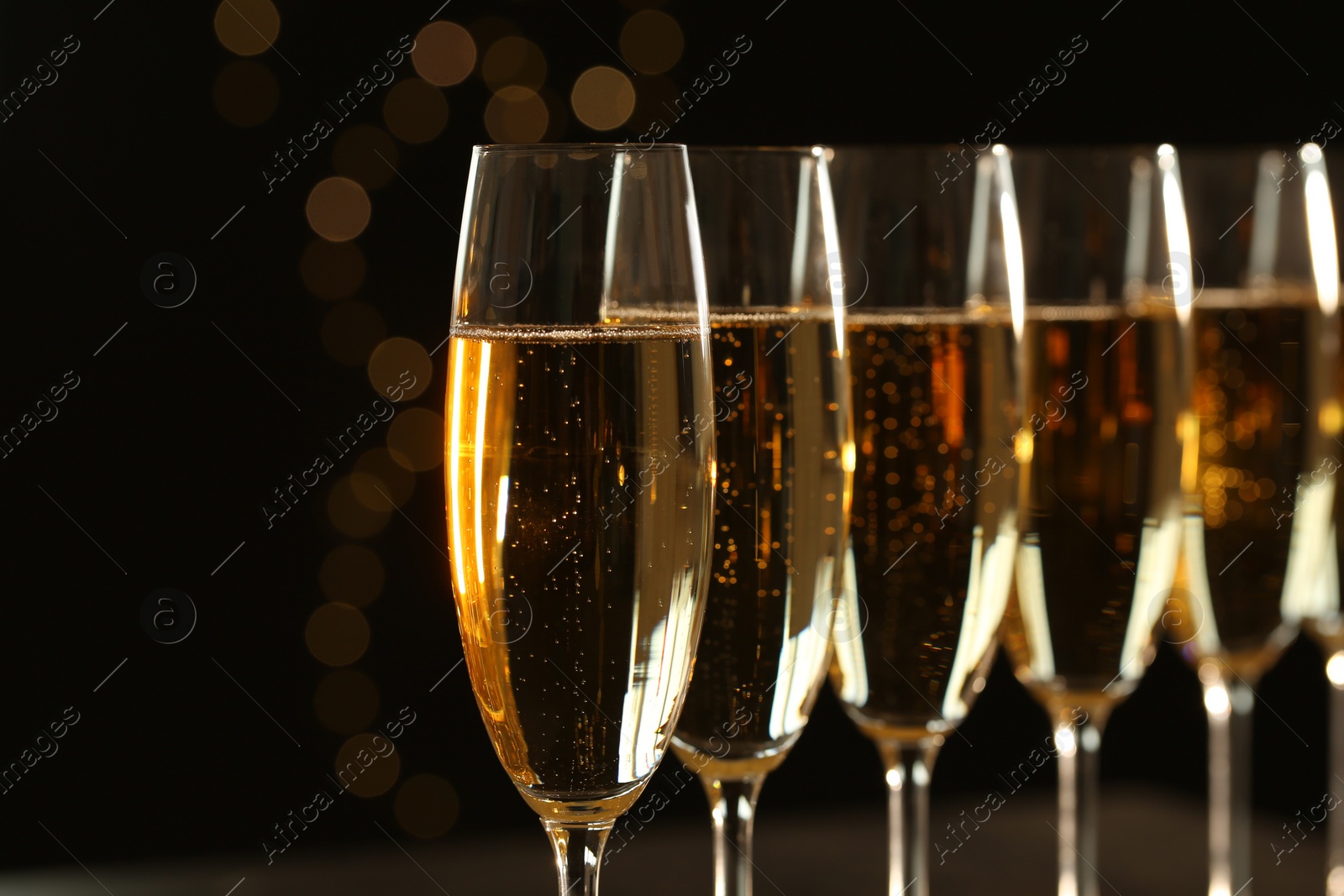 Photo of Glasses of champagne on blurred background, closeup. Space for text