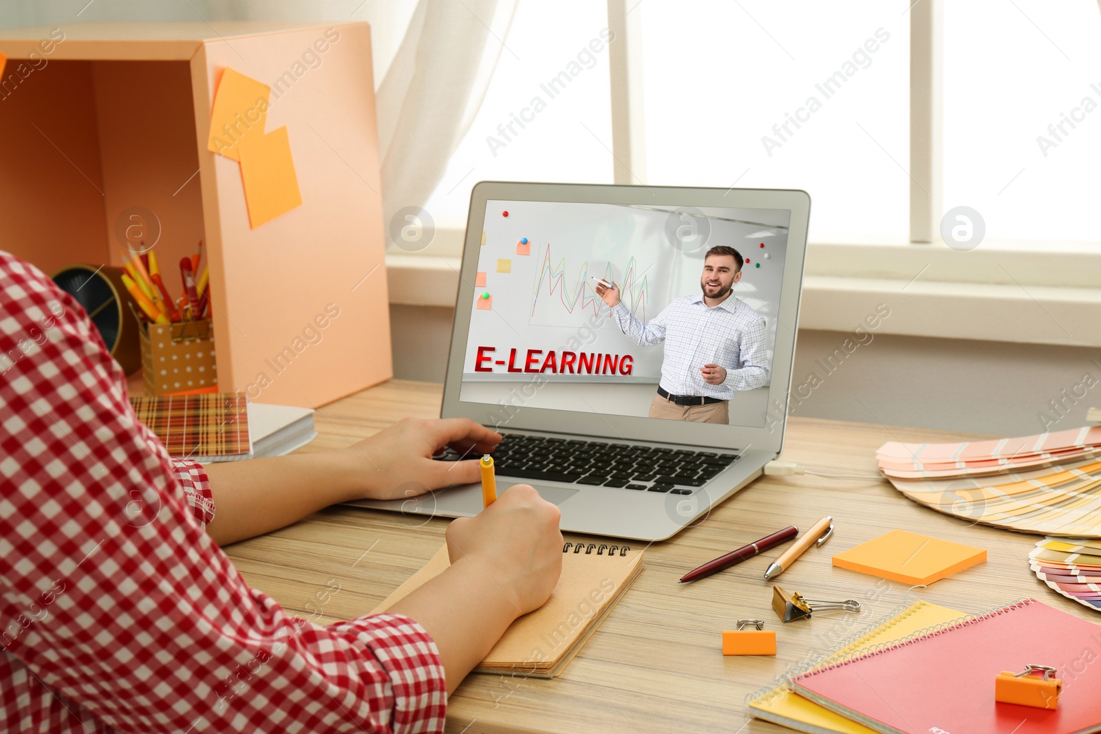 Image of Young woman using laptop for online studying at home, closeup