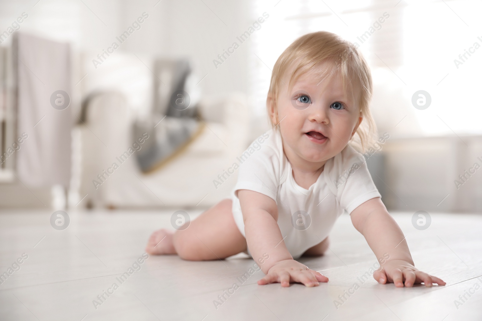 Photo of Cute little baby on floor at home