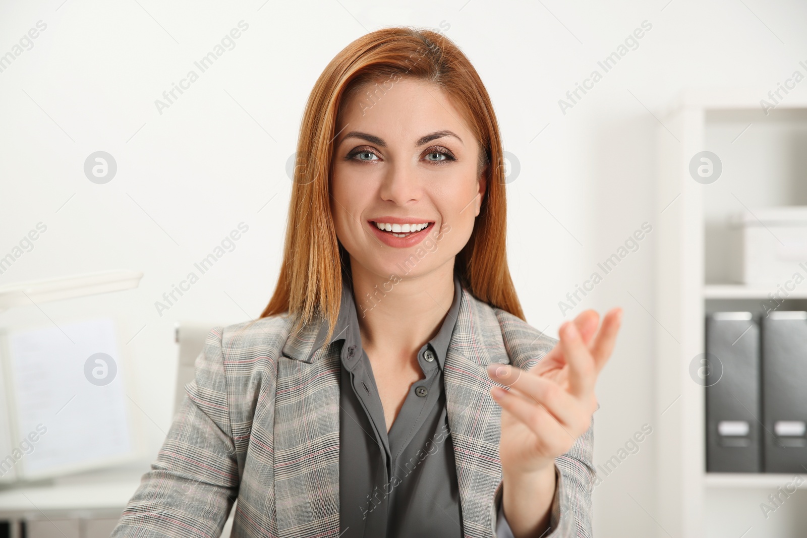 Photo of Happy woman using video chat in modern office, view from web camera