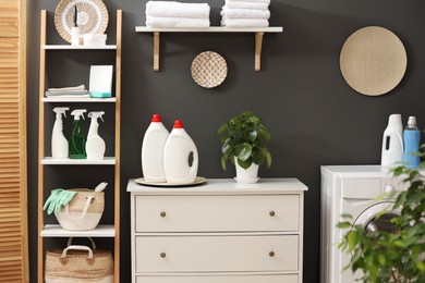 Photo of Laundry room interior with washing machine and furniture