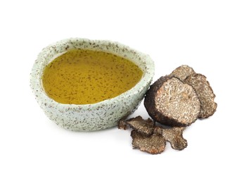Photo of Bowl of oil and fresh truffles on white background