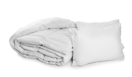 Clean blanket and pillows on white background