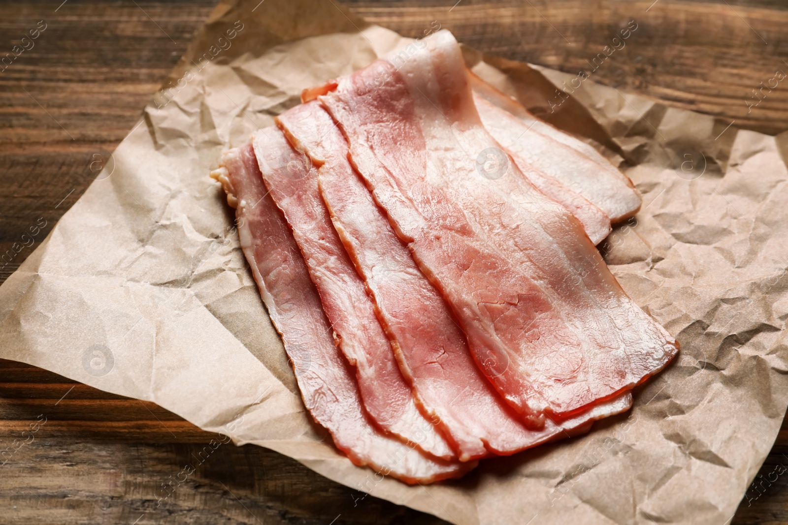 Photo of Raw bacon rashers on parchment