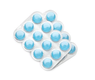 Photo of Blisters with blue cough drops on white background, top view