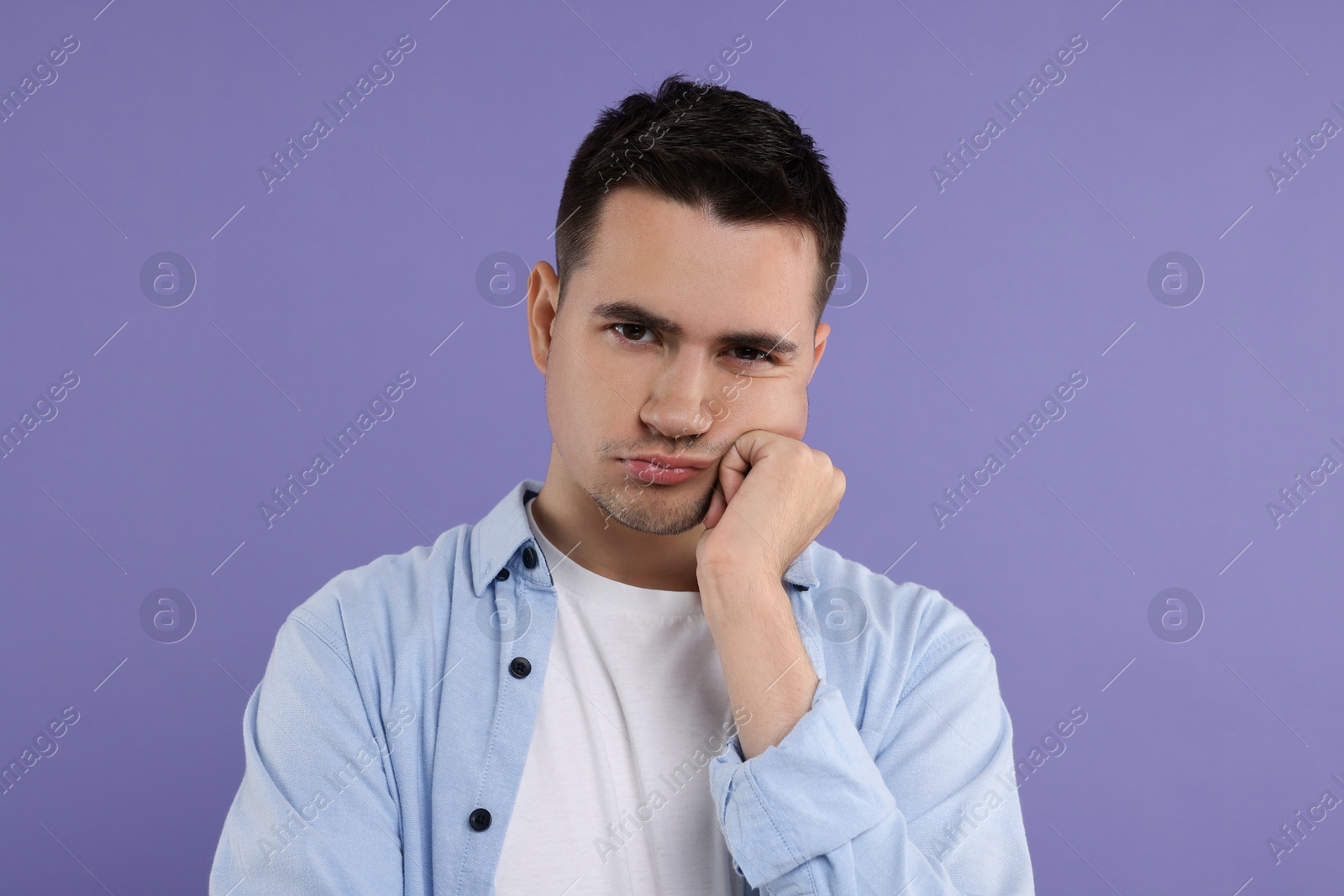 Photo of Portrait of resentful man on violet background