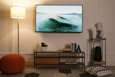 Photo of Stylish room interior with modern TV, cabinet and decor