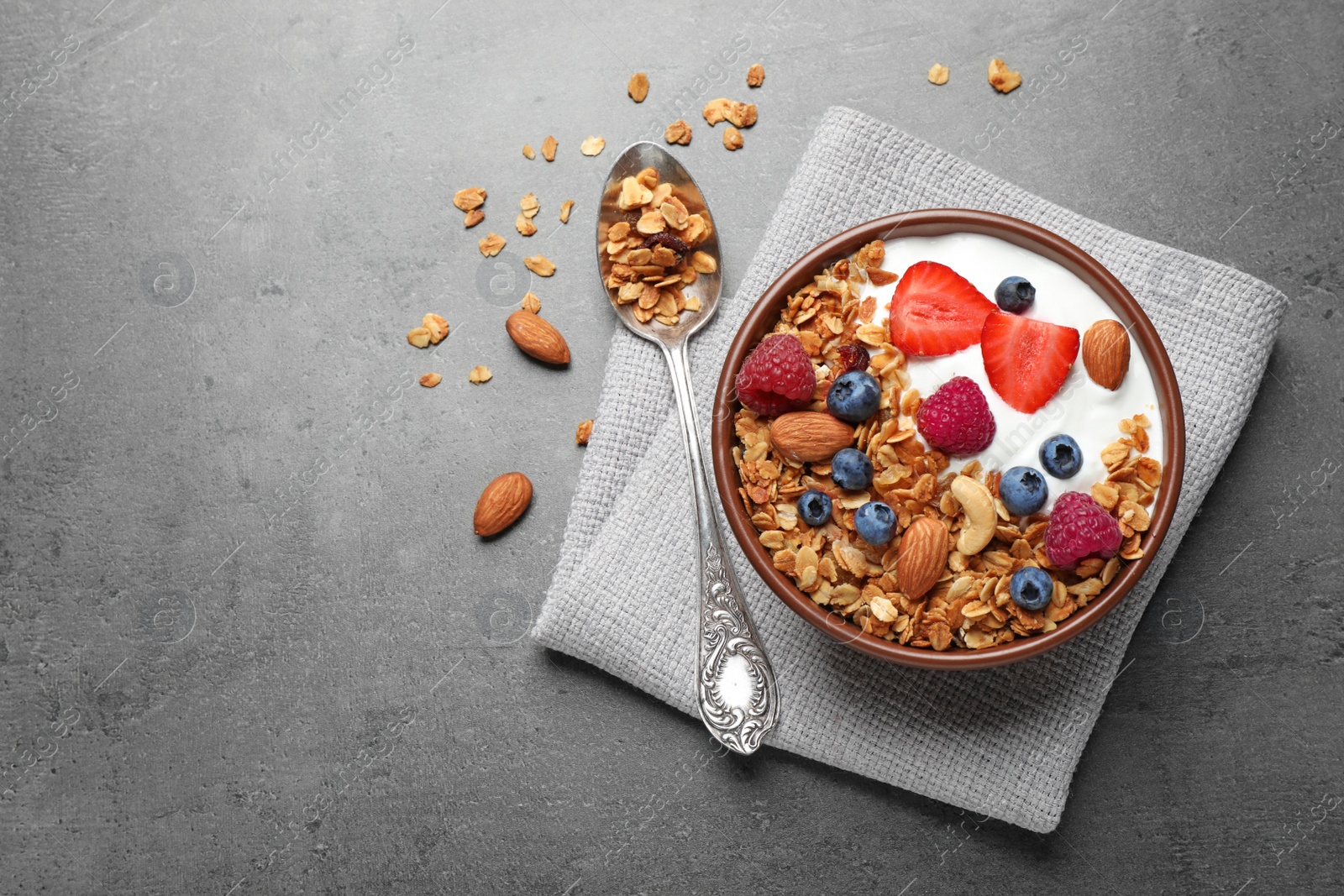 Photo of Tasty homemade granola  served on grey table, flat lay with space for text. Healthy breakfast