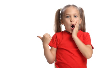 Photo of Special promotion. Emotional little girl pointing at something on white background
