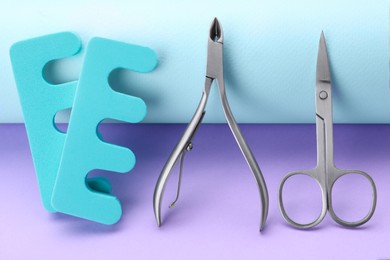 Photo of Set of pedicure tools on color background, closeup