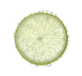 Fresh lime slice in sparkling water on white background