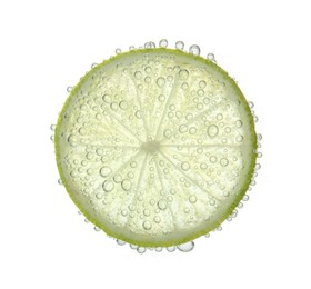 Photo of Fresh lime slice in sparkling water on white background