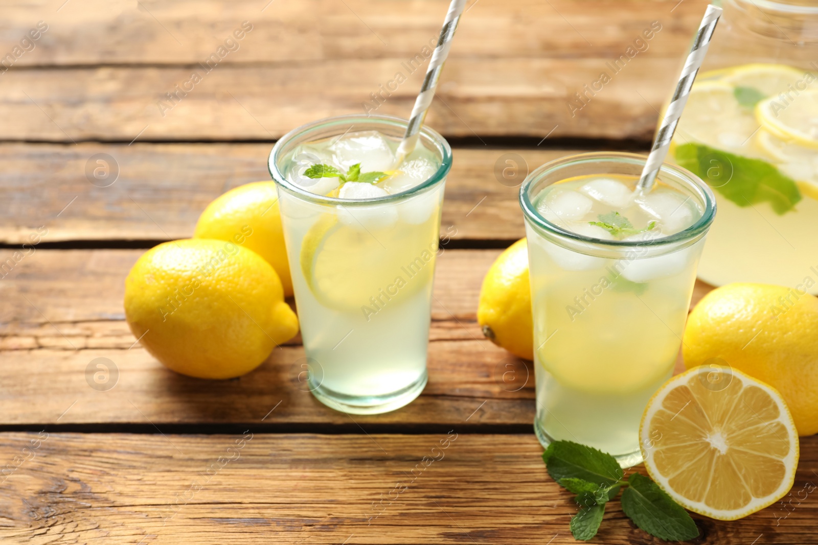 Photo of Natural lemonade with mint on wooden table. Summer refreshing drink