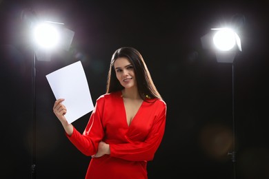 Photo of Happy actress with script performing on stage. Film industry