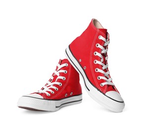 Pair of new red stylish high top plimsolls on white background