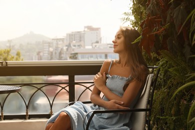 Beautiful young woman on balcony. Space for text