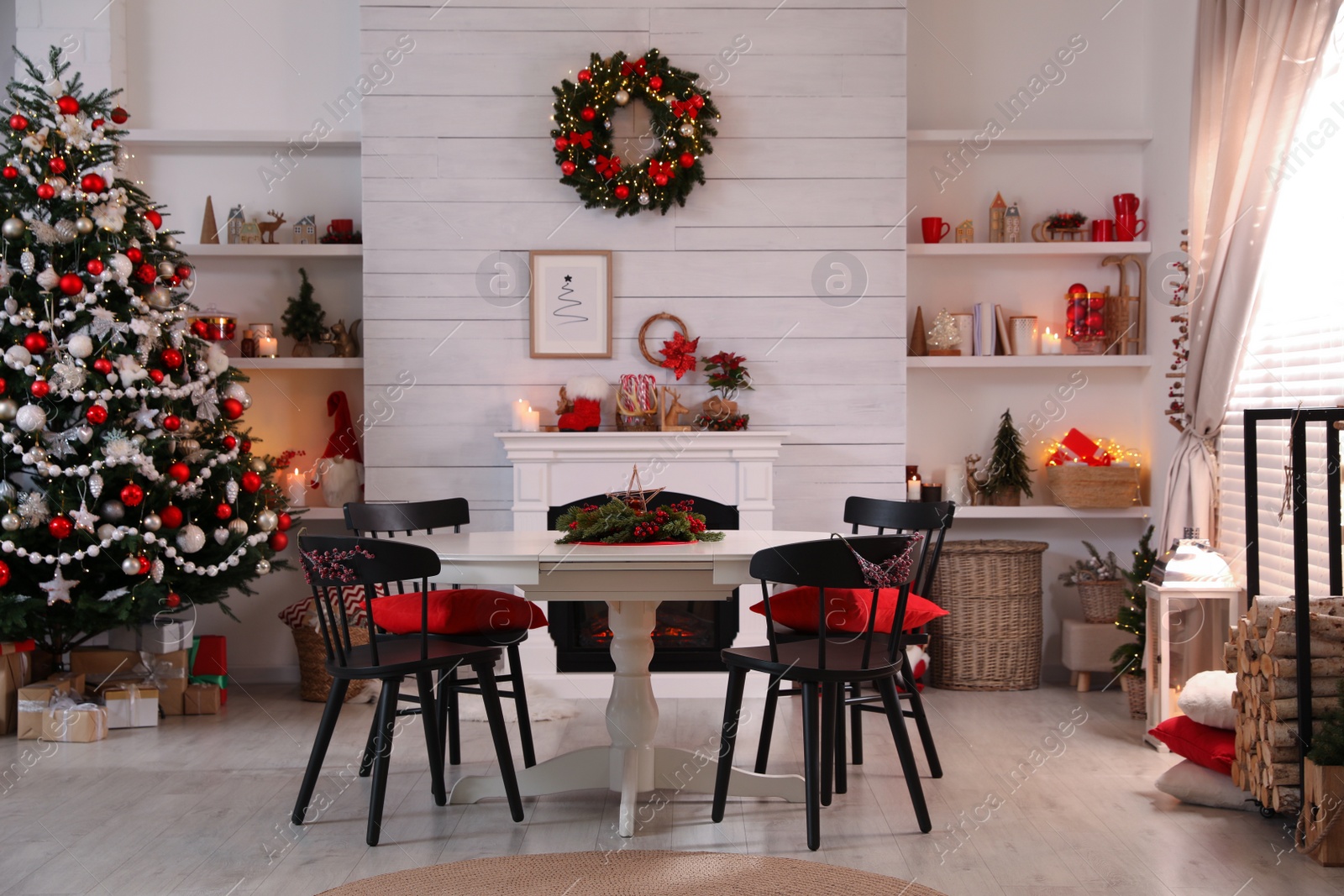 Photo of Cozy dining room interior with Christmas tree and festive decor