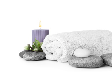 Photo of Composition with spa stones, towel and candles isolated on white
