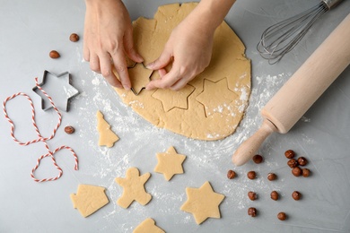 Photo of Young woman preparing Christmas cookies on table, top view