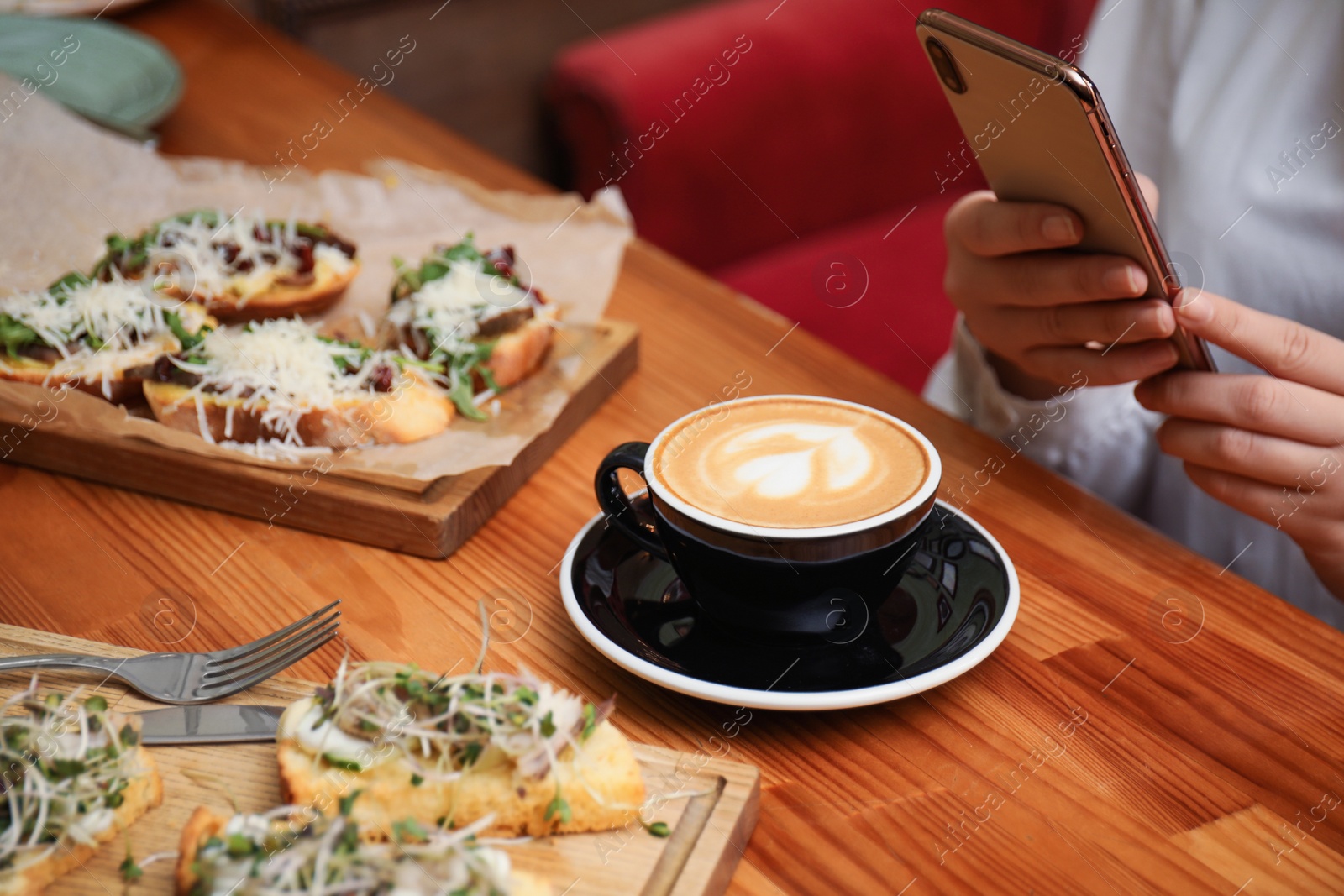 Photo of Food blogger taking photo of her lunch at cafe, closeup