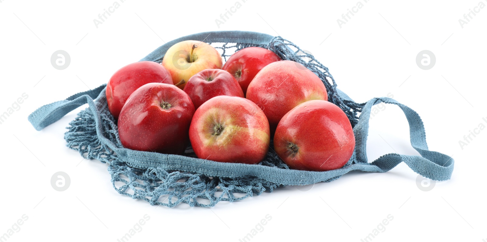 Photo of String bag with apples isolated on white