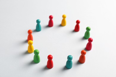 Colorful pawns on white background. Social inclusion concept