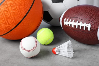 Photo of Set of different sport balls and shuttlecock on light grey table