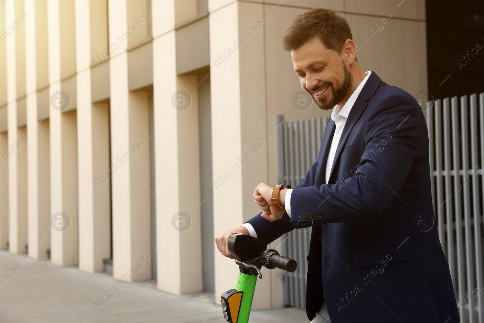 Photo of Businessman with modern kick scooter on city street, space for text