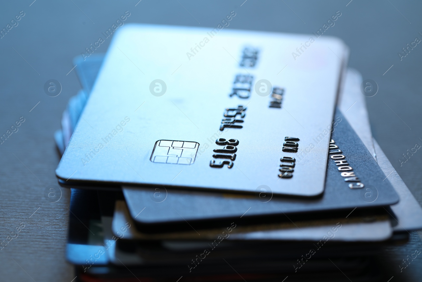 Photo of Many credit cards on gray background, closeup view