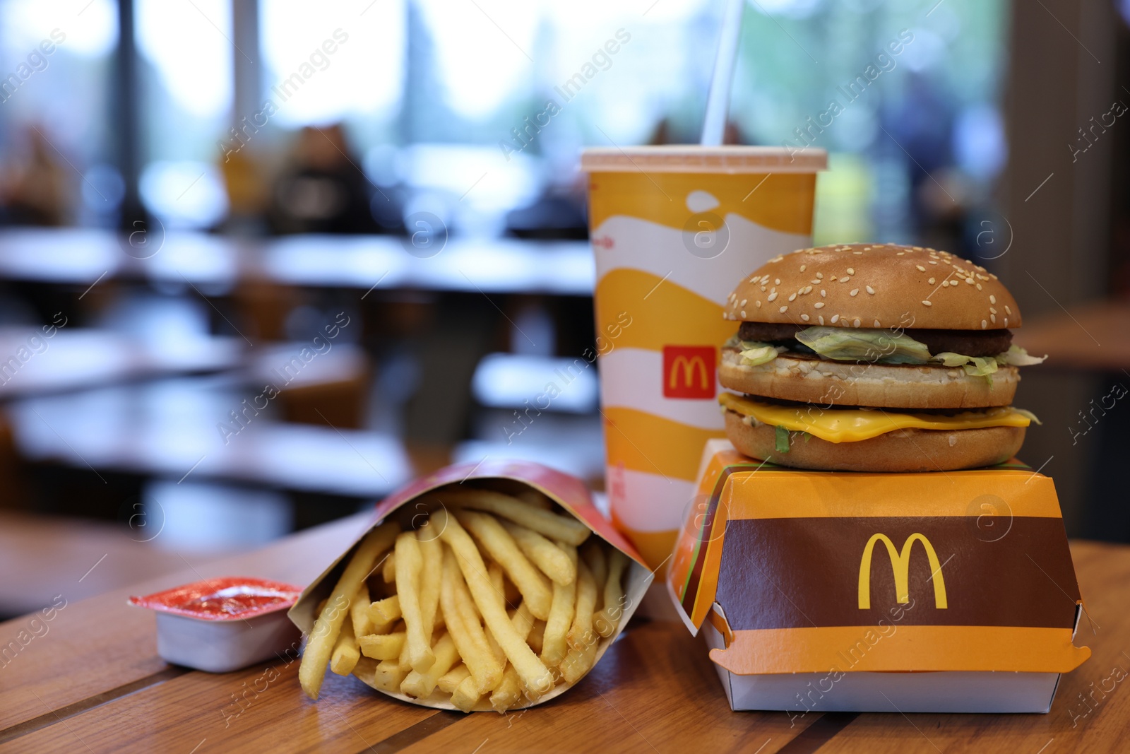 Photo of Lviv, Ukraine - October 9, 2023: McDonald's menu on wooden table in restaurant, space for text